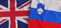 Flags of United Kingdom and Slovenia. Linen flags close-up. Flag made of canvas. Great Britain. Yuk. Lublyana. State national