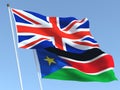 The flags of United Kingdom and South Sudan on the blue sky. For news, reportage, business. 3d illustration
