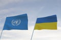 Flags of UNITED NATIONS,UN and RUSSIA waving with cloudy blue sky background,3D rendering WAR