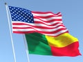 The flags of United States and Benin on the blue sky. For news, reportage, business. 3d illustration