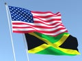 The flags of United States and Jamaica on the blue sky. For news, reportage, business. 3d illustration