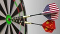 Flags of the USA and China on darts hitting bullseye of the target. International cooperation or competition conceptual Royalty Free Stock Photo