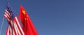 Flags of the USA and China on flagpoles on side. Flags on a blue background. Place for text. United States of America. Beijing, Royalty Free Stock Photo