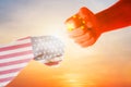 Flags of USA and China  painted on two  fists  on sky background. United States of America versus China trade war disputes concept Royalty Free Stock Photo