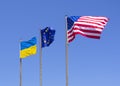Flags of the USA, the European Union and Ukraine are flying in the wind against the blue sky Royalty Free Stock Photo