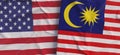 Flags of USA and Malaysia. Linen flag close-up. Flag made of canvas. United States of America. Kuala Lumpur. State national Royalty Free Stock Photo