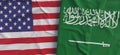 Flags of USA and Saudi Arabia. Linen flags close-up. Flag made of canvas. United States of America. Riyadh. State national symbols Royalty Free Stock Photo