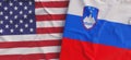 Flags of USA and Slovenia. Linen flags close-up. Flag made of canvas. United States of America. Lublyana State national symbols.