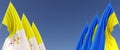 Flags of the Vatican and Ukraine on flagpoles on sides. Flags on blue background. Place for text. Independent free Ukraine. Three