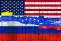 Flags of Venezuela, Russia and the USA on the background texture peeling paint with a crack