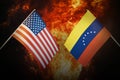 Flags of venezuela and United States of america against background of a fiery explosion. The concept of enmity and war