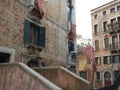 Flags of Venice with a winged lion in front of the house.