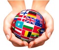 Flags of the world in globe and hand. Royalty Free Stock Photo