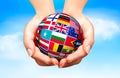 Flags of the world in globe and hand. Royalty Free Stock Photo