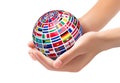 Flags of the world on a globe, held in hands. Royalty Free Stock Photo