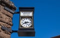 A street analog clock, on a stone building, is the timekeeper for the citizens. Space, empty. Flagstaff, Arizona, US