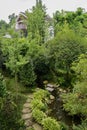 Flagstone footpath to house in verdant summer woods