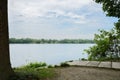 Flagstone path on shady lakeside in cloudy summer