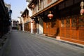 Flagstone-paved street between old-fashioned buildings in sunny Royalty Free Stock Photo