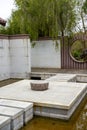 A flagstone recreational walkway over a pond in a traditional Chinese garden Royalty Free Stock Photo