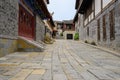 Flagstone street on upslope between old-fashioned tile-roofed bu