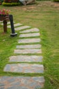 Flagstone walkway on a grassy field Royalty Free Stock Photo