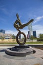 The Flair Olympic Statue in Georgia International Plaza with lush green trees and grass and a gorgeous clear blue sky Royalty Free Stock Photo