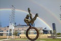 The Flair Olympic Statue in Georgia International Plaza with lush green trees and grass and a gorgeous clear blue sky Royalty Free Stock Photo