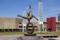 The Flair Olympic Statue in Georgia International Plaza with lush green trees and grass and a gorgeous clear blue sky Royalty Free Stock Photo