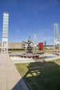 The Flair Olympic Statue in Georgia International Plaza with lush green trees and grass and a gorgeous clear blue sky