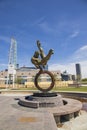 The Flair Olympic Statue in Georgia International Plaza with lush green trees and grass and a gorgeous clear blue sky Royalty Free Stock Photo