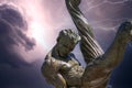 The Flair Olympic Statue in Georgia International Plaza with storm clouds and lightning at the Georgia World Congress Center