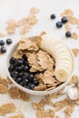 Flakes with blueberries and banana on brown bowl Royalty Free Stock Photo