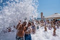Flakes of snow-white foam fall asleep on cheerful people on the beach, 09/07/2019, Yalta, Crimea