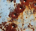 Flaking paint and bullet holes on rusty metal plate Royalty Free Stock Photo