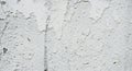Flaking white paint on a cracked aged stucco wall surface Royalty Free Stock Photo