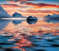 Flakstadoya island reflected in calm waters of Norwegian sea.