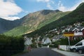 houses and cars in Flam village near beautiful mountains Norway