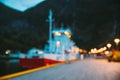 Flam, Norway. Touristic Ship Boat Moored Near Berth In Sognefjord Port. Summer Evening. Abstract Boke Bokeh Background Royalty Free Stock Photo