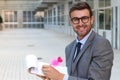 Flamboyant businessman taking notes with a cute pink pen Royalty Free Stock Photo