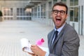 Flamboyant businessman taking notes with a cute pink pen Royalty Free Stock Photo