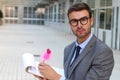 Flamboyant businessman taking notes with a cute pink pen Royalty Free Stock Photo