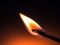 flame of a burning match on a dark background