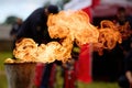 Flame Burst. A dramatic burst of fire from a torch against an outdoor backdrop. Royalty Free Stock Photo