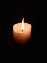 the flame of a candle bright in the dark Royalty Free Stock Photo