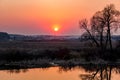 Flame-colored sunset over water