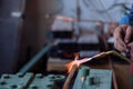 Flame of a copper welding machine heats a copper pipe in a workshop Royalty Free Stock Photo