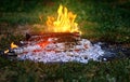 Flame of a fire burning in the dark night and the burning coals that give warmth to the hearth in the wild. Royalty Free Stock Photo