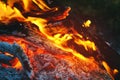 Flame of a fire burning in the dark night and the burning coals that give warmth to the hearth in the wild. Royalty Free Stock Photo