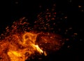 Flame of fire with sparks on a black background Royalty Free Stock Photo